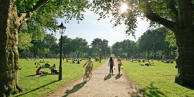 Public walking through Queen Square on a sunny summer day.